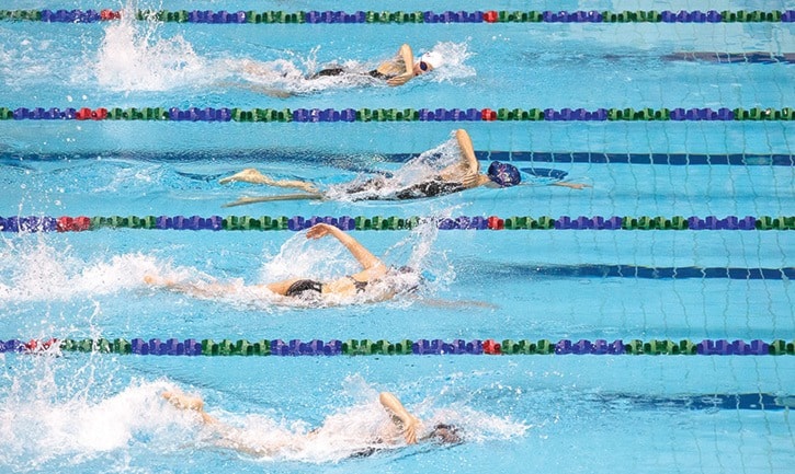 Swimmers compete in the Men 200 Free Relay during Pacific Coast Swimming Christmas Cracker Invitational.