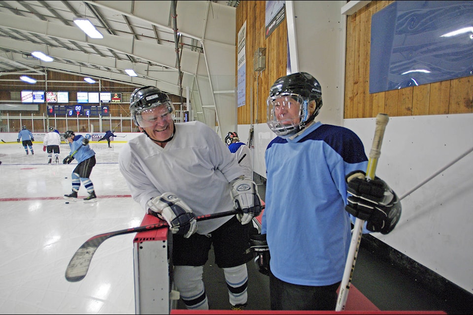 Bruce Donaldson and Sid Greenner share a laugh while waiting to start playing hockey Oct. 6 at Panorama. They were among the people who were the first players to use the new ice surface and rink. (Steven Heywood/News staff)