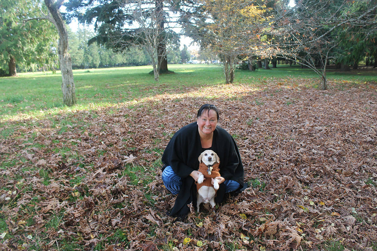 Saanich resident Melissa Hyland and her dog Butters enjoy a mild and moderately sunny day at Kings Park on Tuesday, Nov. 5, 2019. (Sophie Heizer/News Staff)