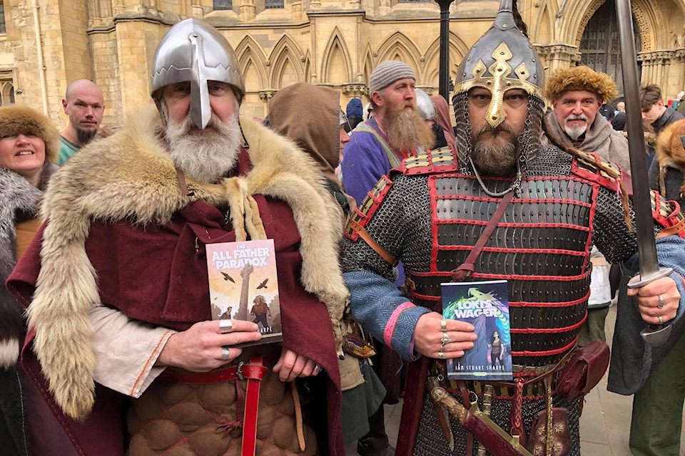 Visitors to York, England, for the 36th annual Jorvik Viking Festival show their copies of books purchased from Oak Bay author Ian Sharpe. (Courtesy of Ian Sharpe)