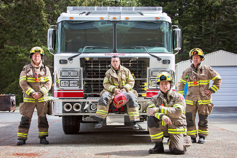Firefighters Michael Poole (from left), Captain Bryan Erwin, Bryan McNeil and Josh Pettigrew get acquainted with Colwood Fire Rescue’s new engine. See story on page A5. (Katherine Engqvist/News Staff)