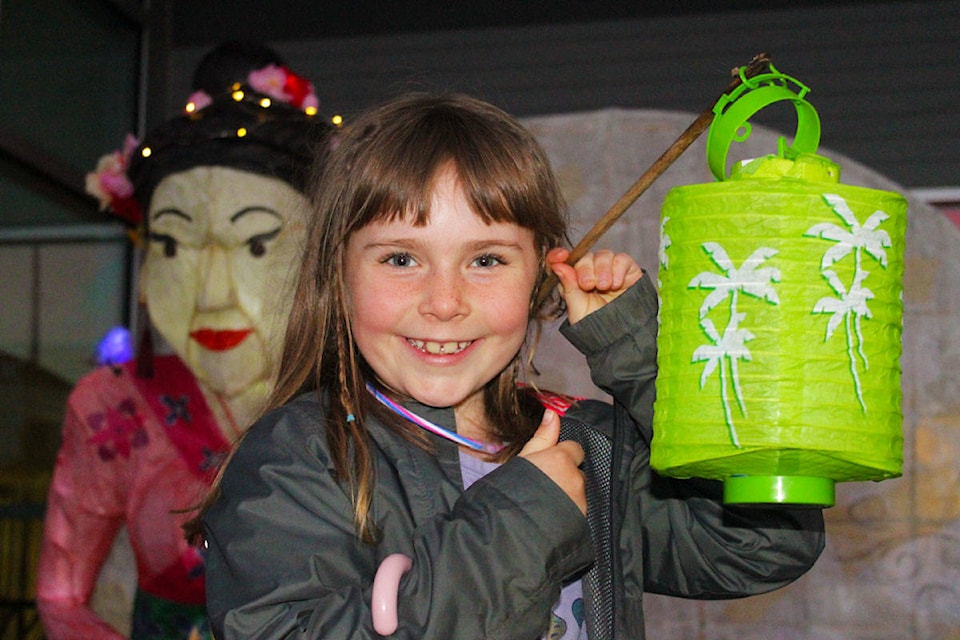 Thea Driver, 6, brought her own lantern to the Saanich Moon Festival Lantern Celebration for a mini lantern procession as she toured the displays with her family. Colourful paper lanterns and displays glowed in Gordon Head on Saturday night as residents on foot, on bikes and in cars celebrated the annual Moon Festival Lantern Celebration. See story and photos on page A28. (Devon Bidal/News Staff)