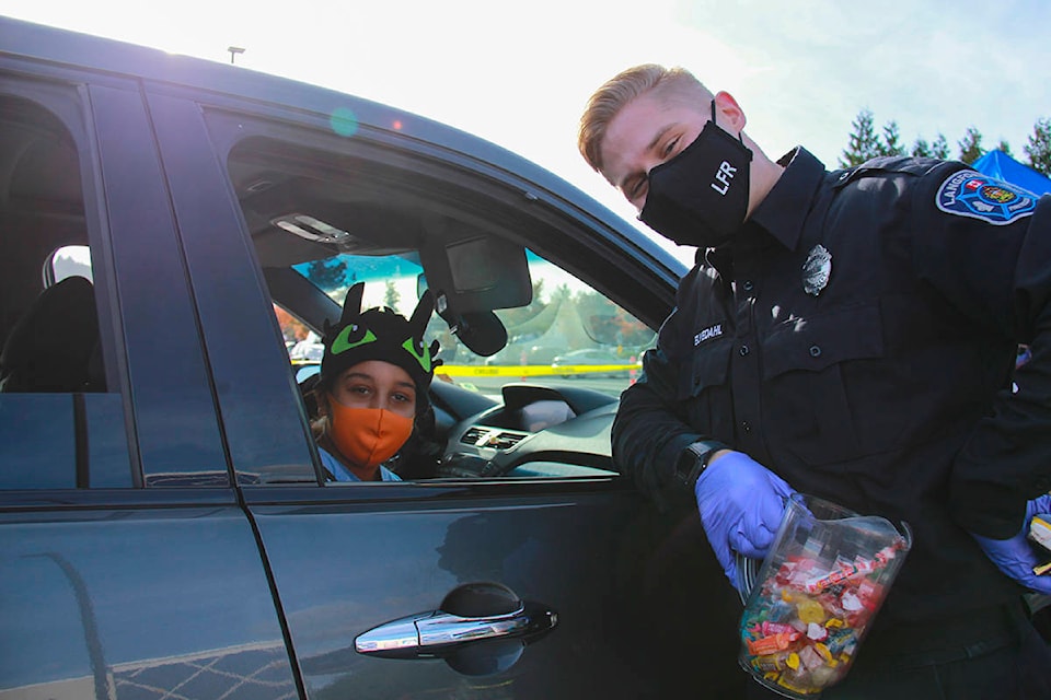 The Langford Fire Rescue team was busy Saturday afternoon handing out heaps of candy during its first ever Halloween drive-thru. (Jane Skrypnek/News Staff)