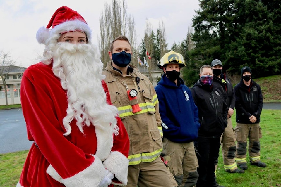 Santa Claus stopped by Colwood City Hall to help ring in the holidays with members of the Colwood Volunteer Firefighters’ Association. Members collected donations for the Goldstream Food Bank while spreading some holiday cheer. (Aaron Guillen/News Staff)