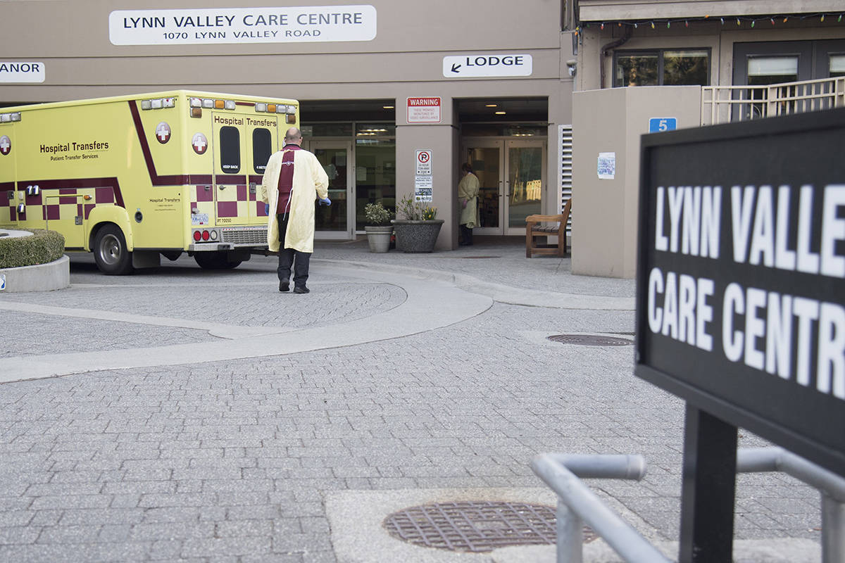 Hospital transfer workers are seen outside the Lynn Valley Centre care home in North Vancouver, B.C. Wednesday, April 8, 2020. THE CANADIAN PRESS/Jonathan Hayward