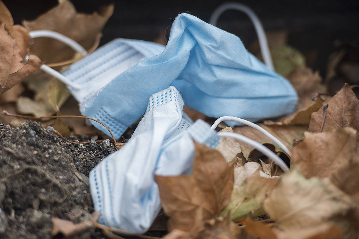 Discarded blue surgical fame masks are shown amongst leaves in Montreal, Sunday, November 15, 2020, as the COVID-19 pandemic continues in Canada and around the world.THE CANADIAN PRESS/Graham Hughes