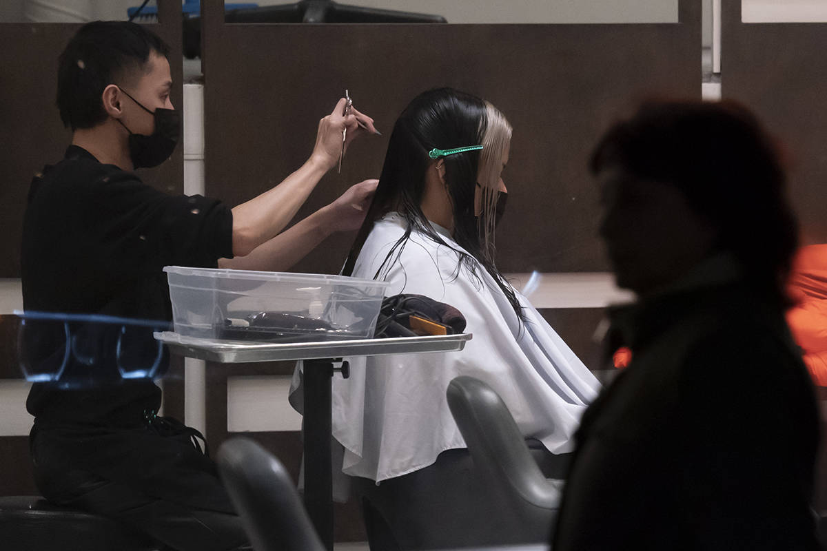 People wear protective face masks to help prevent the spread of COVID-19 at a hair salon in Yaletown in Vancouver, Thursday, December 3, 2020. THE CANADIAN PRESS/Jonathan Hayward