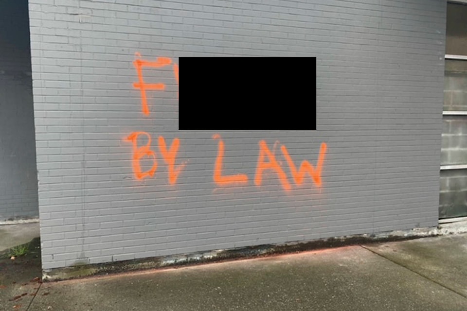 Various Victoria locations were hit with a slew of anti-bylaw graffiti Wednesday. This image has been altered to cover up profane language. (Submitted photo)