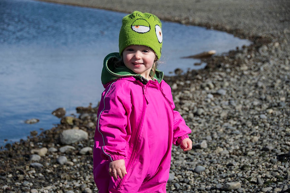 June Saxe, 2, enjoys the sunny shoreline at Whiffin Spit with her dad on March 5. The family had come out from Victoria for a day in the sunshine. (Nina Grossman/News Staff)