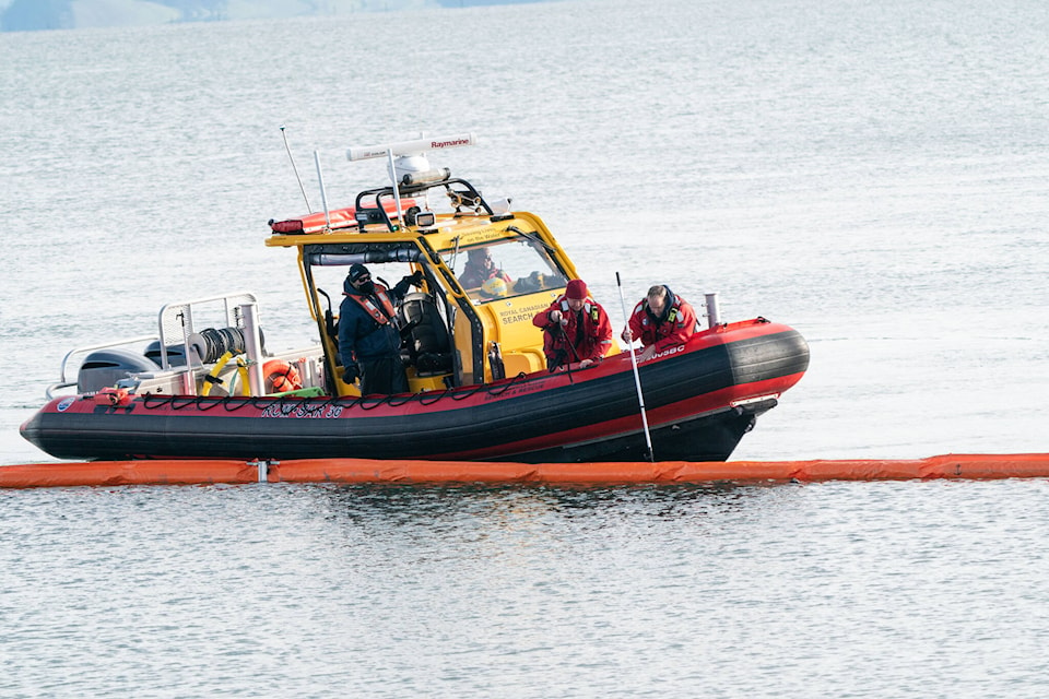Royal Canadian Marine Search and Rescue Station 36 volunteers learn how to deploy a boom as part of spill response training with a Western Canada Marine Response Corporation crew Thursday off the shores of downtown Sidney. (Photo by Bob Orchard)