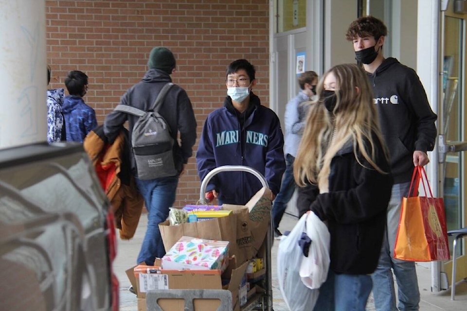 Oak Bay High students fill three pickups with food for the Mustard Seed Food Bank. (Christine van Reeuwyk/News Staff)