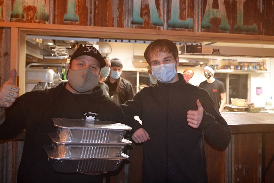 Ronnie Lee, left, holds three turkey platters ready to be delivered to West Coast homes. (Nora O’Malley photo)