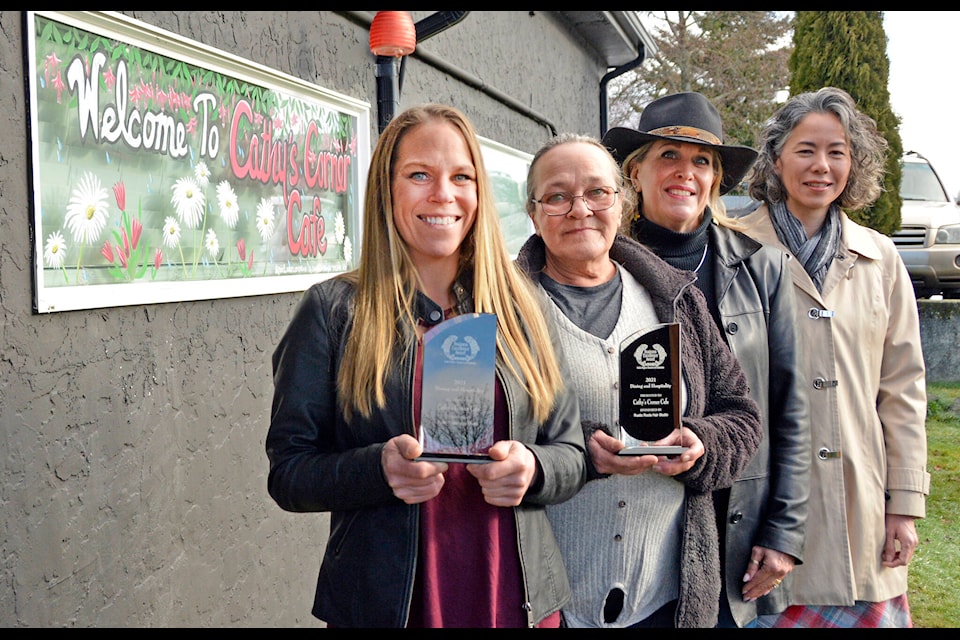 Janice, left, and Cathy Gouk of Cathy’s Corner Cafe receive congratulations from Karen Mason and Maya Maja Tait during a trophy presentation of the Sooke Region Chamber of Commerce Business Excellence Awards on Thursday. (Kevin Laird - Sooke News Mirror)