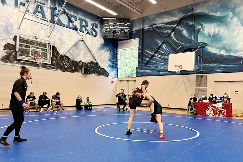 Beatrice Carnell (red shoes) wrestling in a competition. Carnell only started wrestling in November of last year. (Courtesy of Steve Rennalls)