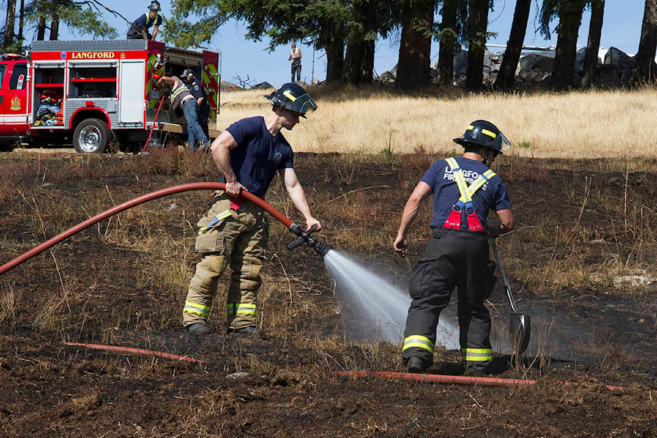 Members of Langford Fire Rescue check for hot spots after a fire off of Latoria Road in 2018. Wildfires are a growing concern as more dry weather is predicted. (Black Press Media file photo)