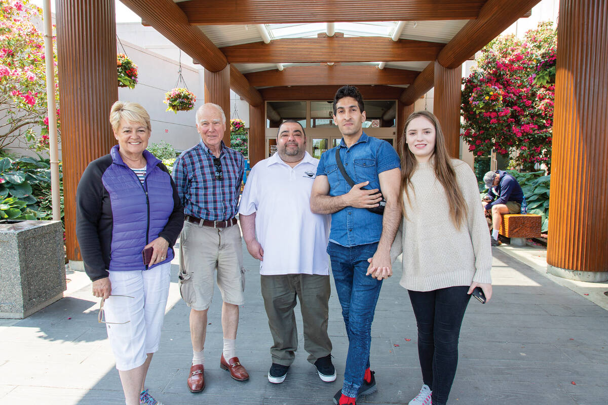 Susan Phillips and Martin Bache, left, with Fawzi Abualhuda and Anastasiia Shevelova, right, who fled Ukraine when the invasion began. Riyaz Rabbani, centre, Recreation Receptionist at Saanich Commonwealth Place, connected the young couple with the LIFE program, which provides for 52 free visits at any Greater Victoria recreation centre.