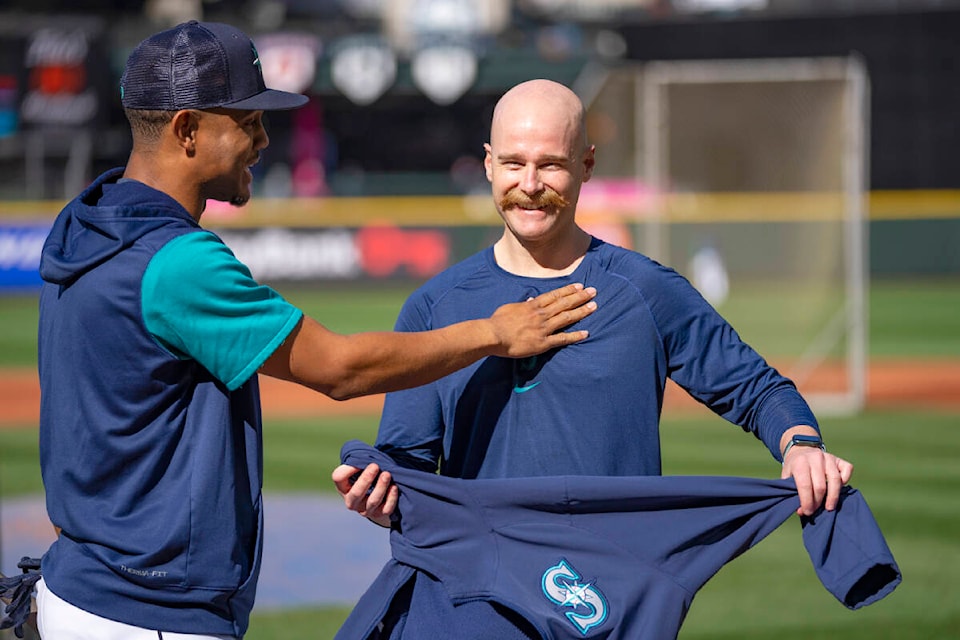 Seattle Mariners field co-ordinator and former Saanich resident Carson Vitale, right, shares a laugh with the team’s rookie star Julio Rodriguez at T-Mobile Park. (Photo by Ben VanHouten/Seattle Mariners)