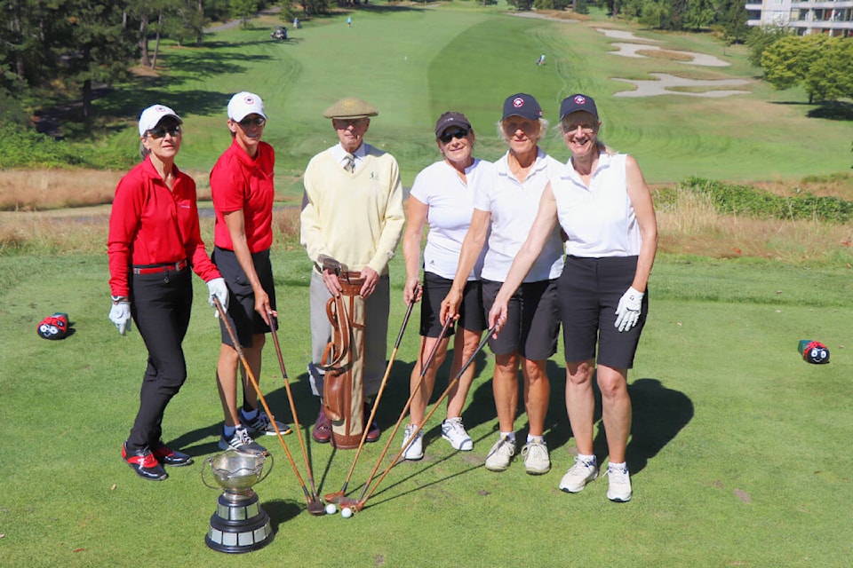 South Island team members Penny Baziuk (from left) and Jackie Hellard, golf historian Mike Riste, and Greater Vancouver team members Diane McFarlane, Elaine Blatchford and Kathryn McGarvey gather holding vintage clubs on the first tee at Gorge Vale Golf Club before the start of the 100th anniversary Huntting Cup competition Monday. The competition alternates between the mainland and Island. (Don Descoteau/News Staff)