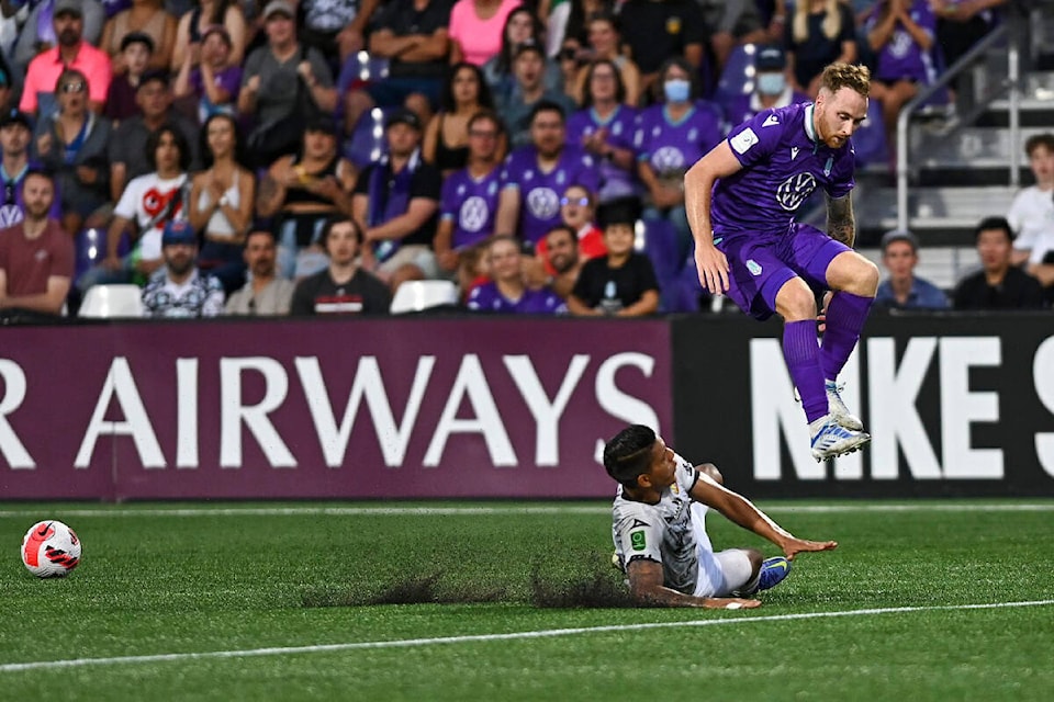 Josh Heard hurdles a challenge from a C.S. Herediano defender during their CONCACAF round of 16 tie at Starlight Stadium on Aug. 16. (Simon Fearn/Black Press Media)