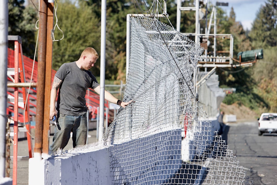 A volunteer tears down fencing in front of the grandstands at Westshore Motorsports Park Saturday, Sept. 24, a week after the track held its final race before shutting down.