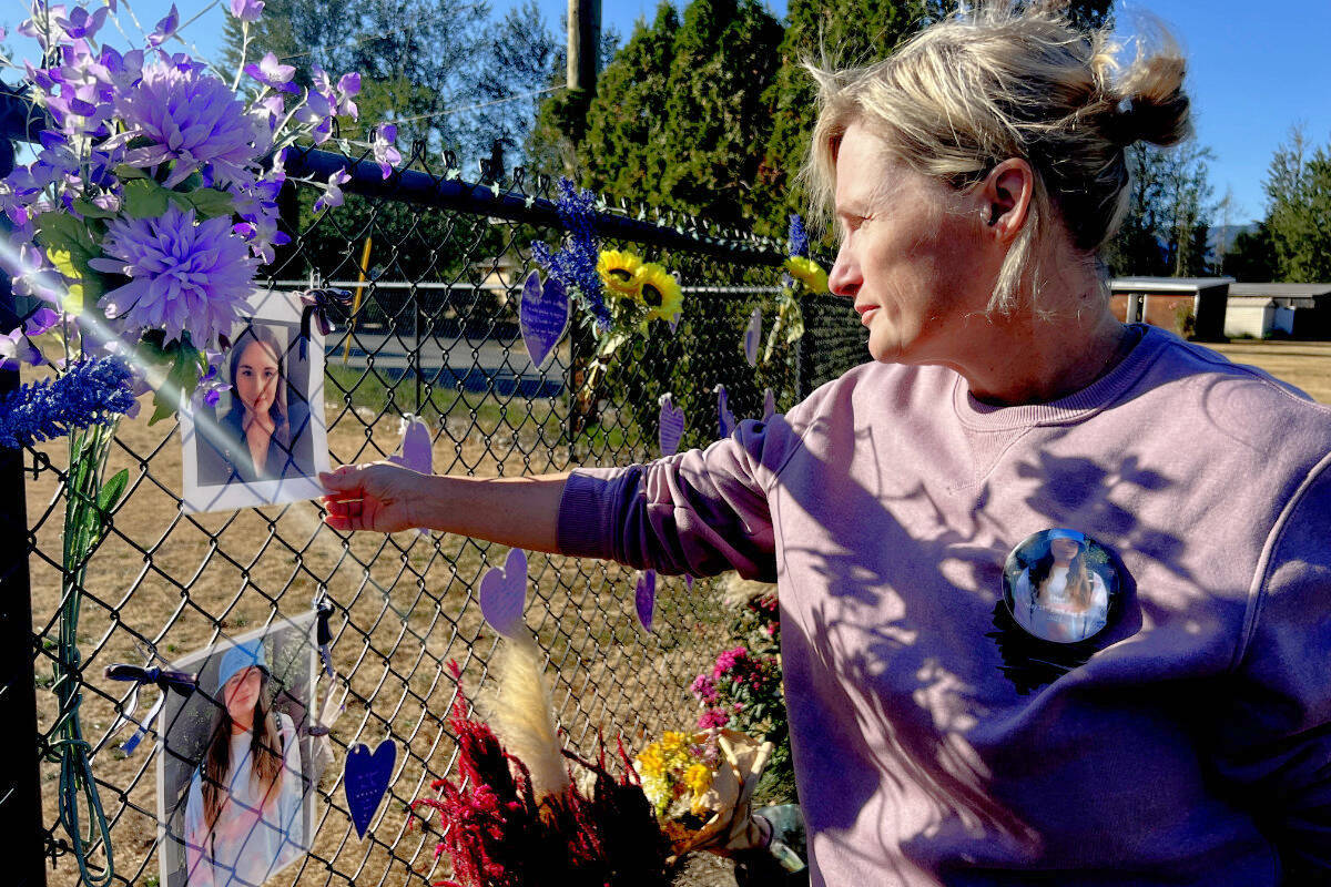 Tara Hartshorne touches a photograph of her daughter Chloe Des Rochers at a memorial at the corner of Ford and Nevin roads in Chilliwack on Sept. 20, 2022. Des Rochers was on a skateboard when she was struck and killed by a pickup truck driver at the interesection on Aug. 1, 2022. (Paul Henderson/ Chilliwack Progress)