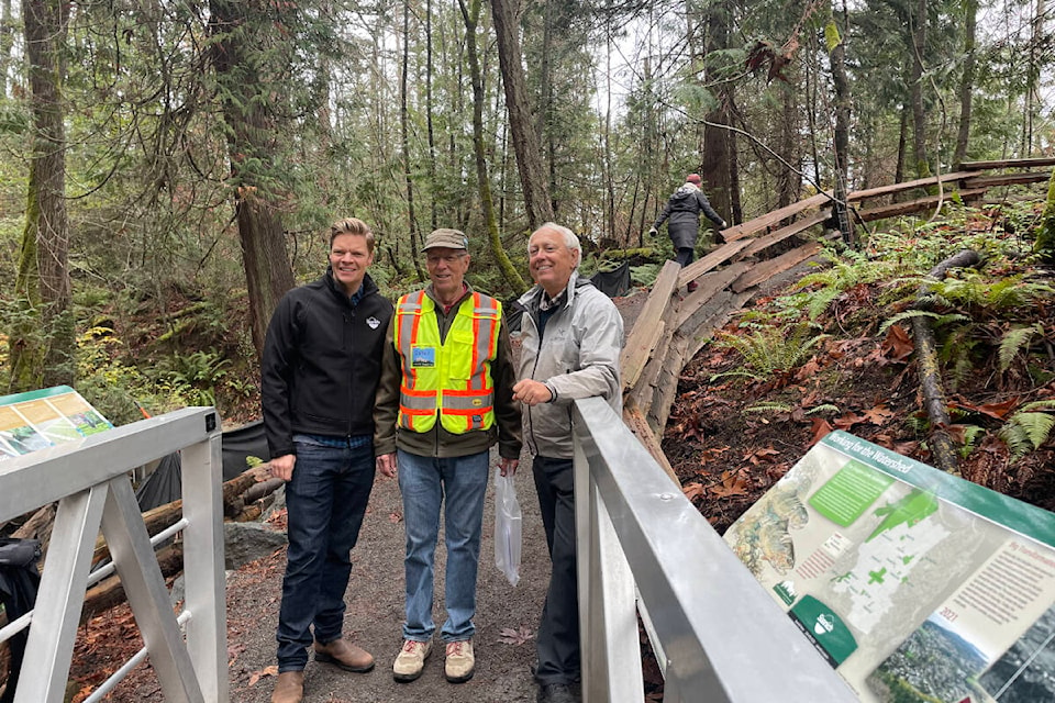 Saanich Mayor Dean Murdoch joins Darrell Wick and Murray Rankin at the end of the new Douglas Creek bridge. (Hollie Ferguson/News Staff)