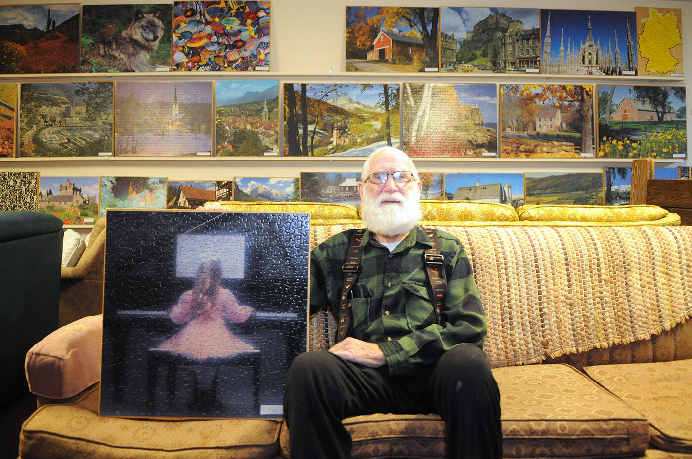 Joe Sommer has completed 190 jigsaw puzzles, all of which are on display in the basement of his Chilliwack home. He is seen here with the very first puzzle he recieved as a gift. (Jenna Hauck/ Chilliwack Progress)