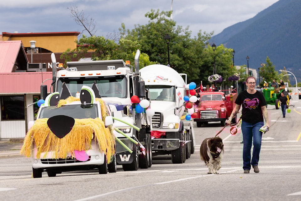 Kelsey McKnight and her pup Berkley accompany the Healthy Spot float in the Salmon Arm Fair parade on Saturday, Aug. 24,  2024. 