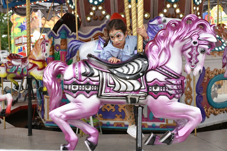 Mira Sran saddles up on a pink pony while enjoying the 125th annual Salmon Arm Fair on Saturday, Aug. 24.