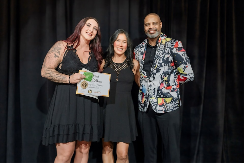 The Shuswap Cider Company's Kailee Ramsell and Lindsay Wong receive a gold medal for the Salmon Arm cidery's Fireside Spice cider at the Northwest Cider Cup in Portland, Ore. on June 20, 2024. 