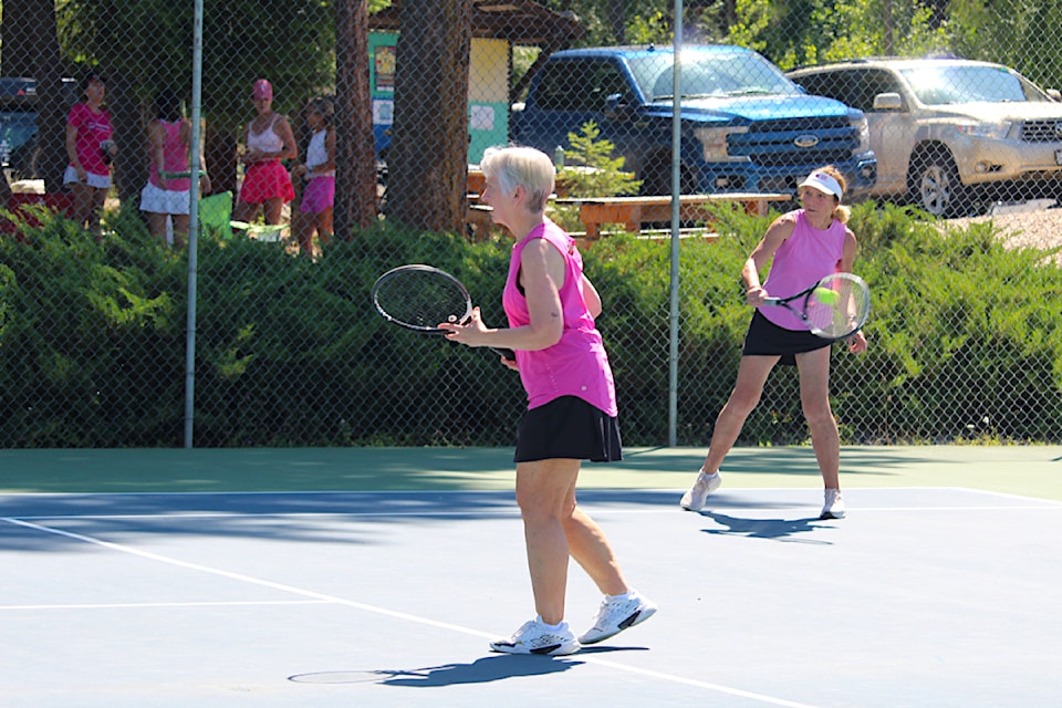 While Rose Sapizak covers the front of the court, teammate Sue Ford returns a serve at the Interior Team Tennis Championships held at the Salmon Arm Tennis Club Saturday, July 6.