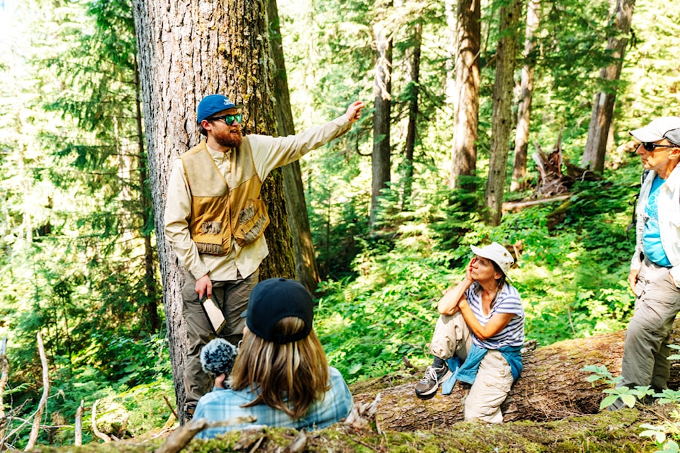 A Kamloops journalist, longtime Seymour resident Lois Bradley and Jim Cooperman look on as Eddie Petryshen talks about the need to protect the forest. 
