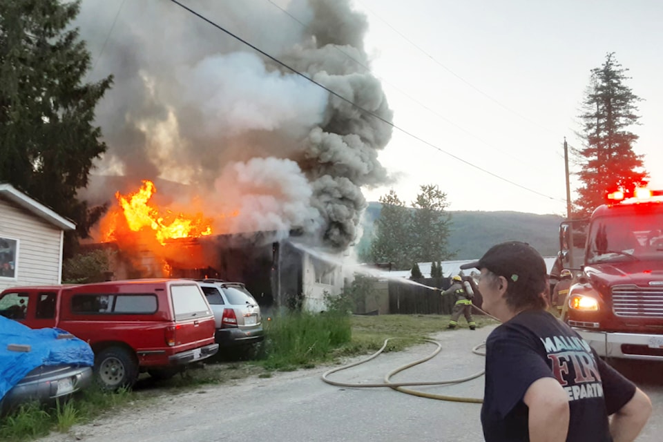 Firefighters respond to the initial blaze at the Green Acres Trailer Park in Malakwa on Monday evening, June 10, 2024.