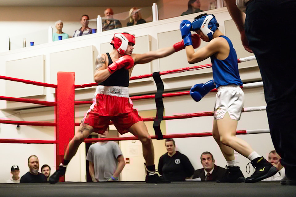Whizbang Boxing's Austin Beasley (red) lands a blow on competitor Carson Sum of Vancouver's Beyond Boxing during the BC Interior Series Amateur Boxing event, held at Song Sparrow Hall on Saturday, Oct. 12, 2024. Beasley went on to win the bout. 