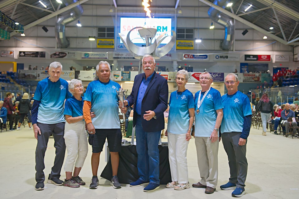 BC Seniors Games Society President John Buis, centre, joins torch bearers Don Hurst, Mary Pakka, Gerry Thomas, Lois Angle, Ralph Owens and Gord Mackintosh. 