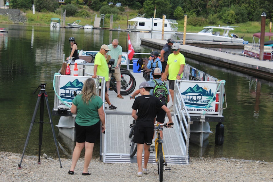 The Sicamous Ferry welcomes the day's first passenger load of bikers and beach goers on Aug. 5, with ridership having already exceeded the society's expectations. 