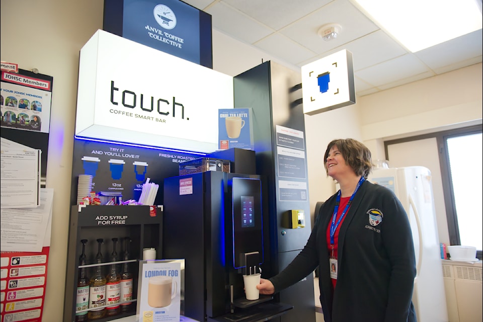Interior Health's Laura Horsthuis grabs a cup of coffee from the new Touch Coffee Smart Bar, with beans from Salmon Arm's Anvil Coffee inside, at Shuswap Lake General Hospital's cafeteria on Thursday, Feb. 20, 2025. 