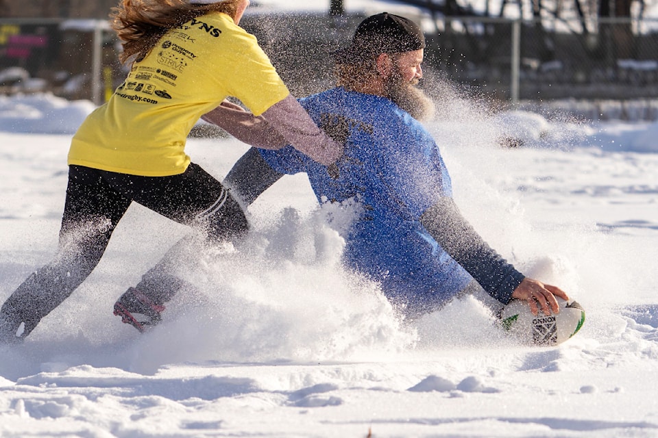 Kelly Hambleton slides in past Keira Jaeger to score during the Yeti Rugby Club's 27th Annual Snow 7s Tournament held in Grindrod on Feb. 18, 2025.