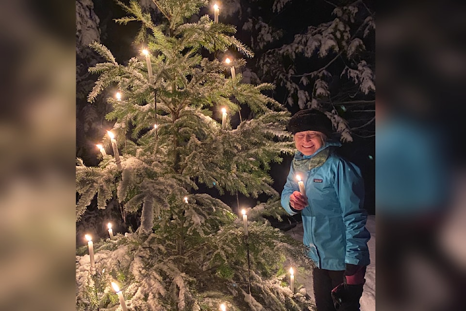 Antje Brugem stops for a break from skiing to enjoy the light of the candle Christmas tree at the Larch Hills Lantern Ski Dec. 28.