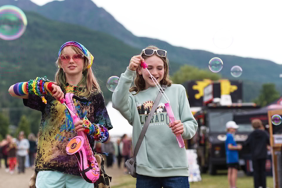 Sayda Bateson and Estelle Stevens create some bubble magic at the ROOTSandBLUES Festival on Friday, July 26, 2025. 