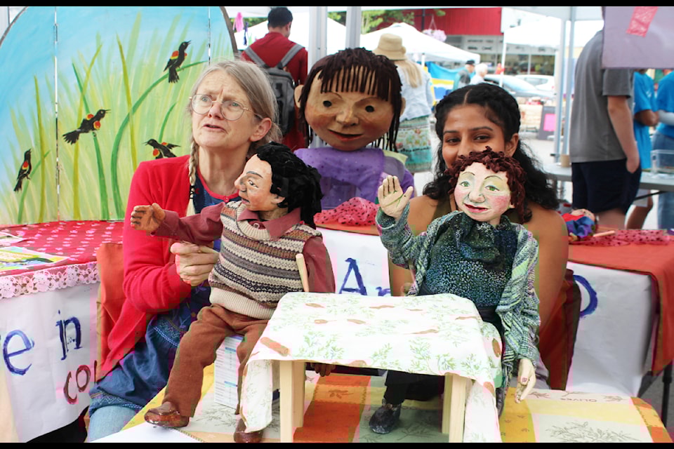 Puppeteers Cathy Stubington, left, and Gureena Saran, with Grindrod's Runaway Moon Theatre, interact with the crowd at Salmon Arm's Gathering Together Festival on Multicultural Day June 28.