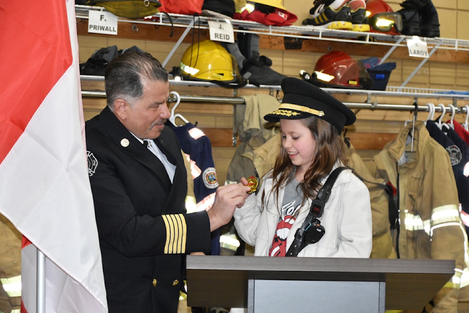 Sicamous Fire Rescue Chief Lorenzo De Arcangelis officially welcomes Avery Sanche, 9, to the crew with a badge designating her the first ever Fire Chief for a Day on Tuesday night, March 4. 