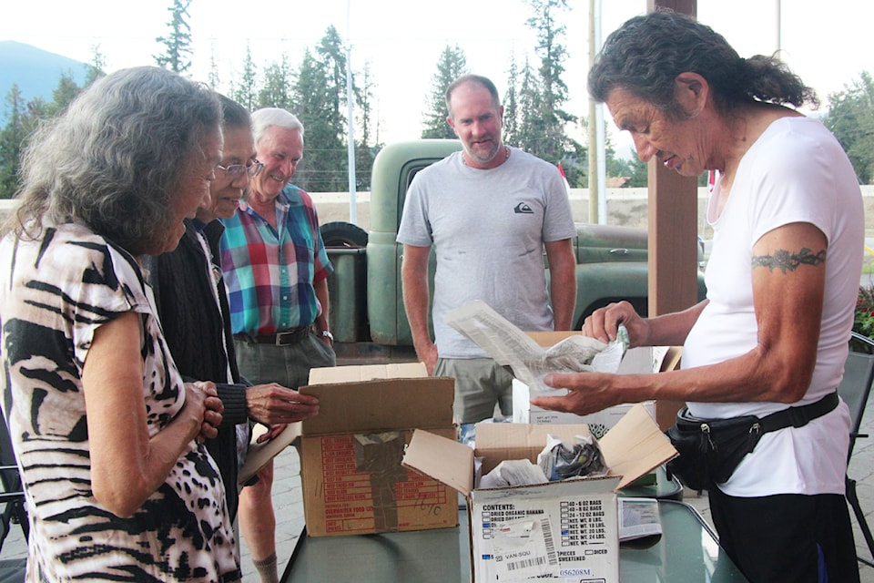 From left, Virginia and Molly Tomma, Paul and Hugh Bennett, and Leo Tomma lookover the artifacts collected in the North Shuswap about 100 years ago and returned to the Tommas in the autumn of 2024.