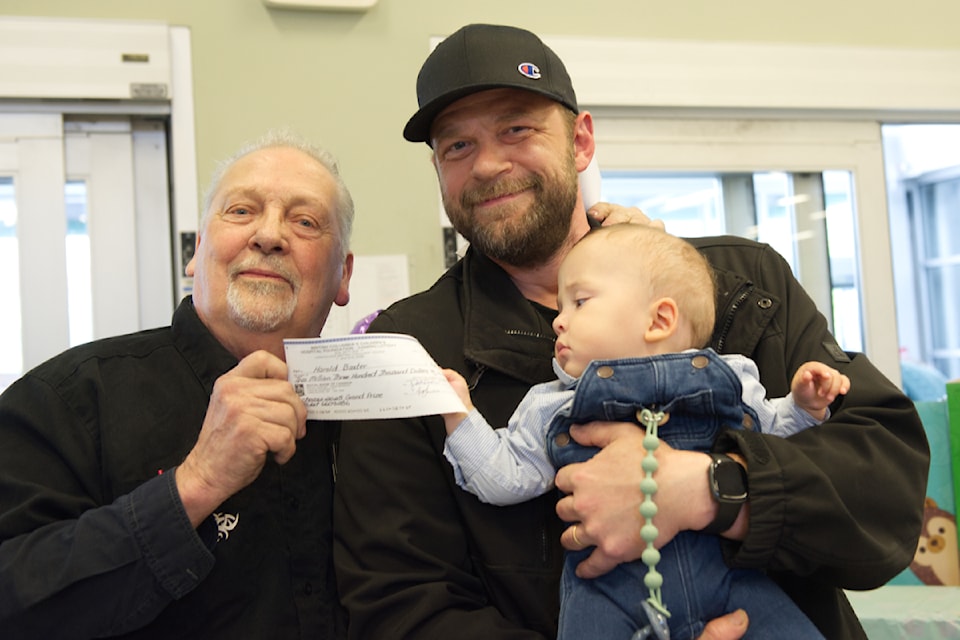 Caleb Cummings, with dad Dave Cummings, helps grandpa Howard Baxter hold the $2.3 million cheque from  BC Children's Hospital Choices Lottery, presented by Salmon Arm Save-On-Foods store manager Nathan Murphy on Monday, May 12, 2025. 