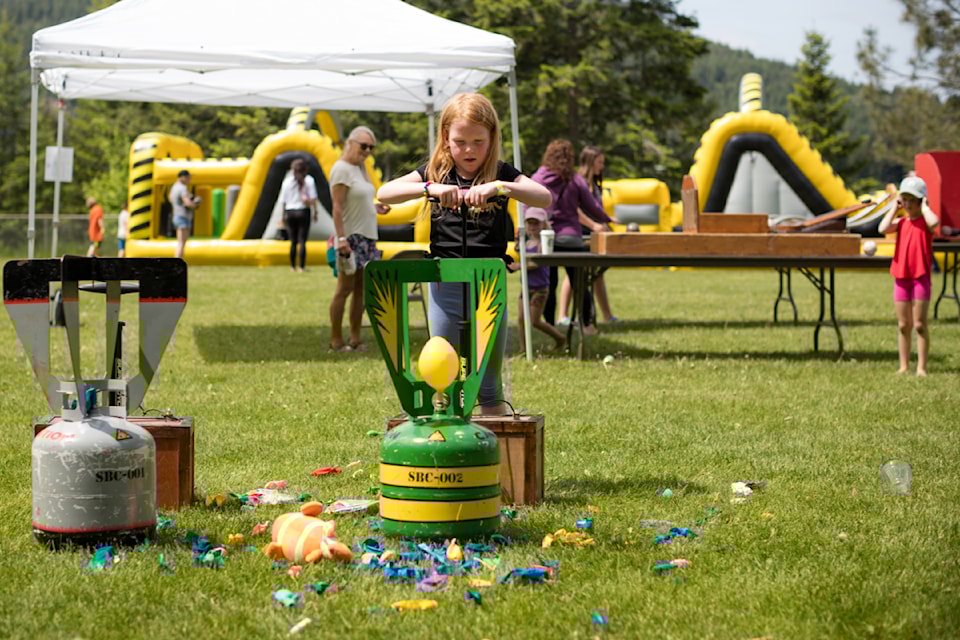 Mackenzie Lysons pumps for another balloon pop at the kids and family activities area of the Carlin Country Market at Carlin Elementary Middle School on Saturday, May 24, 2025. 