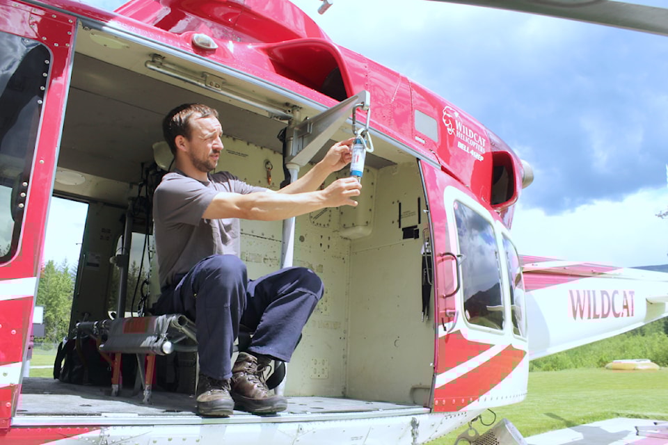 Rapattack aviation specialist Jeremy Neufeld shows the descent device that drops the two crew bags during a tour of the base on May 22.