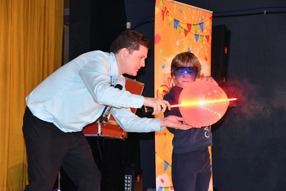 Fletcher Price watches in amazement as magician Leif David pierces a balloon during his Unplug and Play performance at the Salmar Classic Feb. 1.