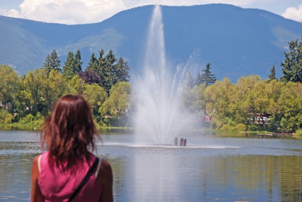 Lori Wheeler admires the new fountain at McGuire Lake.