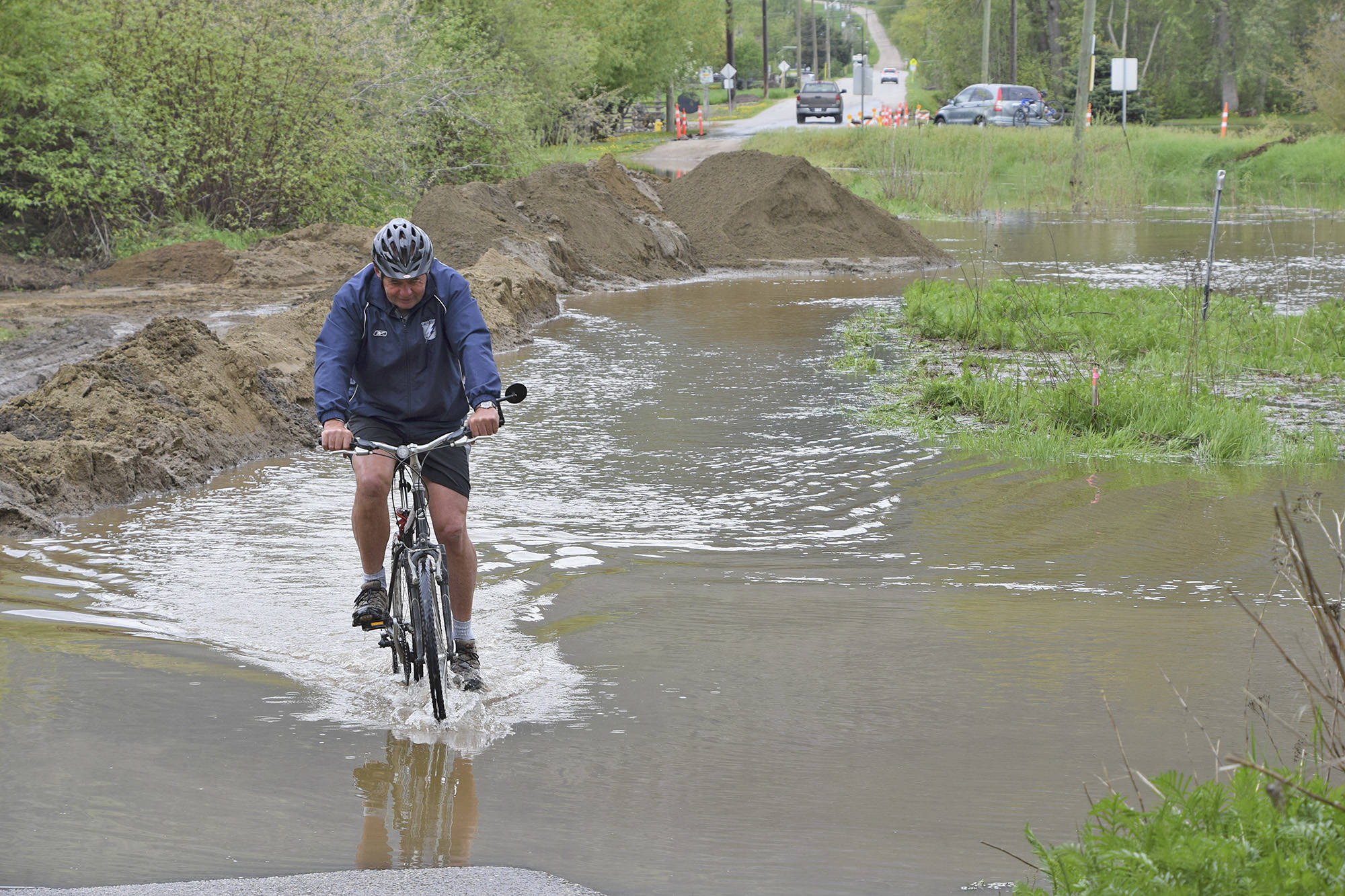 11852004_web1_silver-creek-flood-2018-bike-rider-DSC_2921