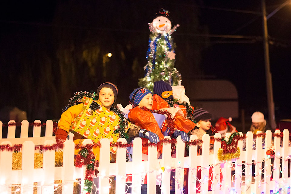 Able Carlson, Nixon Dymond, Owen Wiebe and Logan Wiebe ride the Waterway Houseboats float during the Sicamous Christmas Light-up parade on Saturday, Dec. 1. (Jim Elliot/Eagle Valley News)